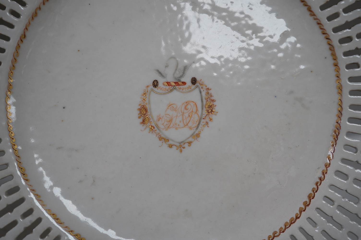 A Chinese pierced and armorial crested porcelain dish, Qianlong, 24.5cm diameter. Condition - a little worn